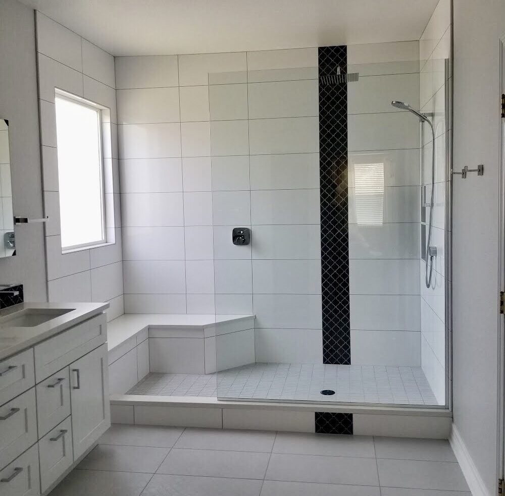 Serene minimalist bathroom with large tiles, example of bathroom remodeler services that can be done by Craftsman Tile and Stone in Franklin, TN. Serene minimalist bathroom with large tiles, bathroom remodel completed by Craftsman Tile and Stone in Franklin, TN.